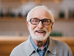 an older man smiling with dentures