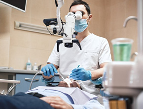Dentist treating a patient while they’re relaxed in the dental chair
