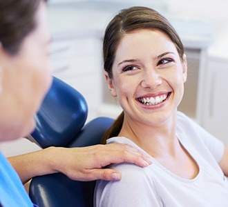 Woman in dental chair smiling