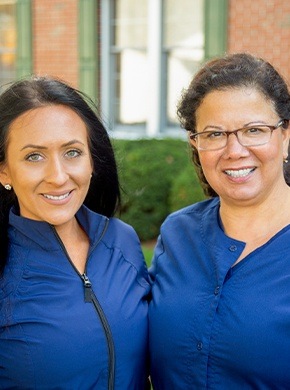 Two dentists looking at patient chart