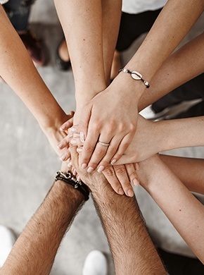 Group of people with hands stacked together