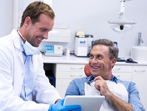 Man at dentist for oral cancer screening in Manchester