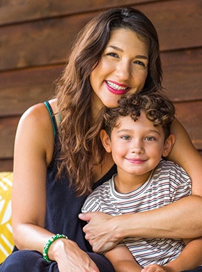 parent and their child sitting on a couch and smiling