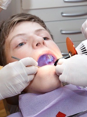 A young patient receiving a tooth-colored filling.