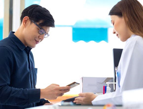 person paying for services in dental office