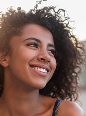 woman smiling with dental crowns in Manchester