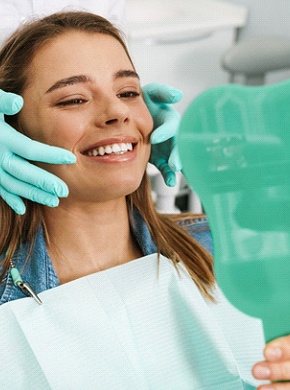 dentist looking at patient’s teeth