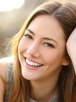 woman smiling after getting dental bridges in Manchester