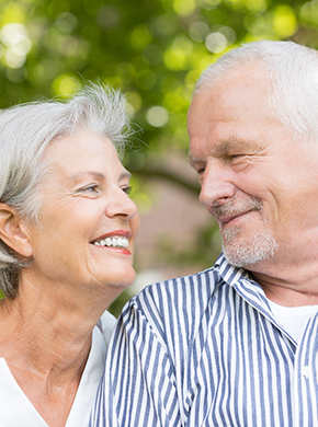 older couple smiling at each other 