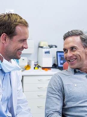 dentist in Manchester talking to patient about dentures