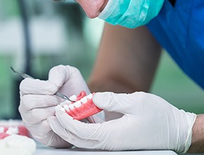 A lab worker making dentures
