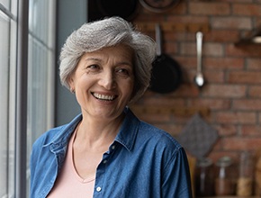 A senior woman enjoying her new dentures