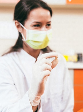 Female patient smiling after successful tooth extraction procedure