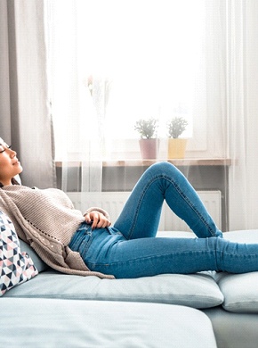 Woman resting at home after tooth extraction appointment