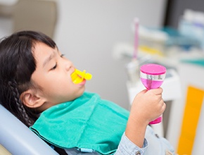 Child receiving fluoride treatment in a dental office
