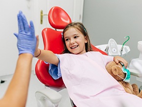 Child giving a dentist a high-five