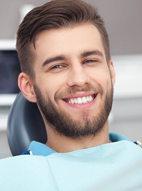 Male dental patient smiling after receiving dental implants in Manchester, NH