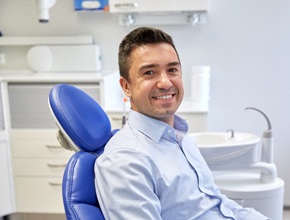 Male dental patient sitting in a dental chair
