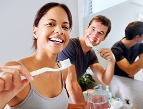 couple brushing their teeth together