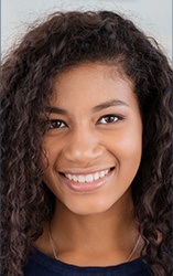 Young woman with curly hair smiling