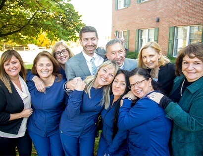 Manchester dentists and dental team members smiling together outdoors