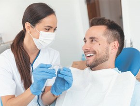 dentist and patient discussing cost of Invisalign in Manchester
