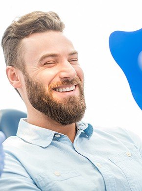 Man smiling at healthier teeth and gums