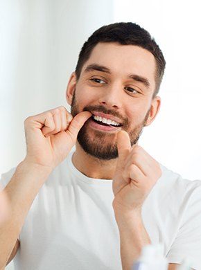Man flossing teeth