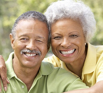 Older man and woman smiling outdoors