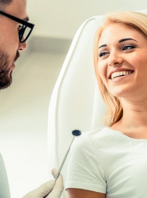 Woman speaking with a cosmetic dentist in Manchester