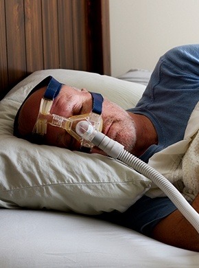 Man sleeping with CPAP mask