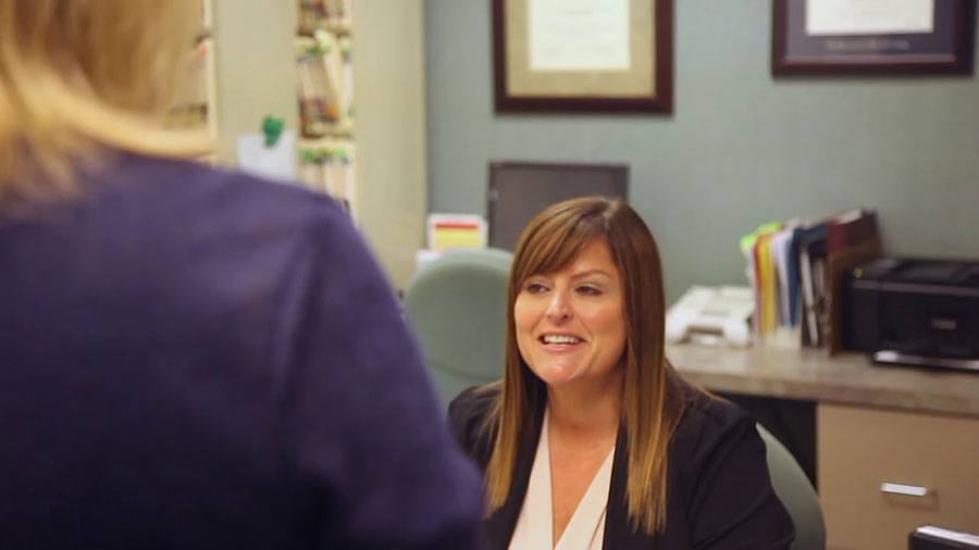 Dental team member talking to patient in Manchester dental office