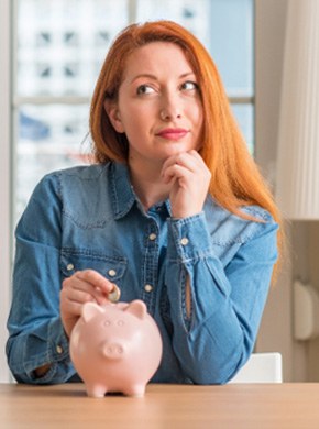 woman and piggy bank for cost of teeth whitening Manchester  