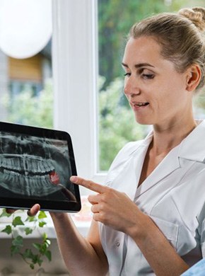 Patient and dental team member discussing X-ray