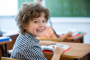 Smiling boy in classroom