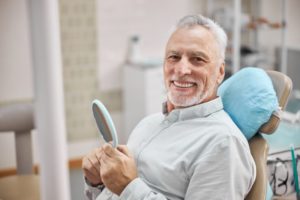 senior man with a dental membership plan visiting his dentist 