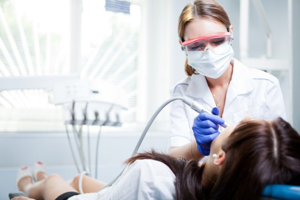Dental hygienist conducting a teeth cleaning