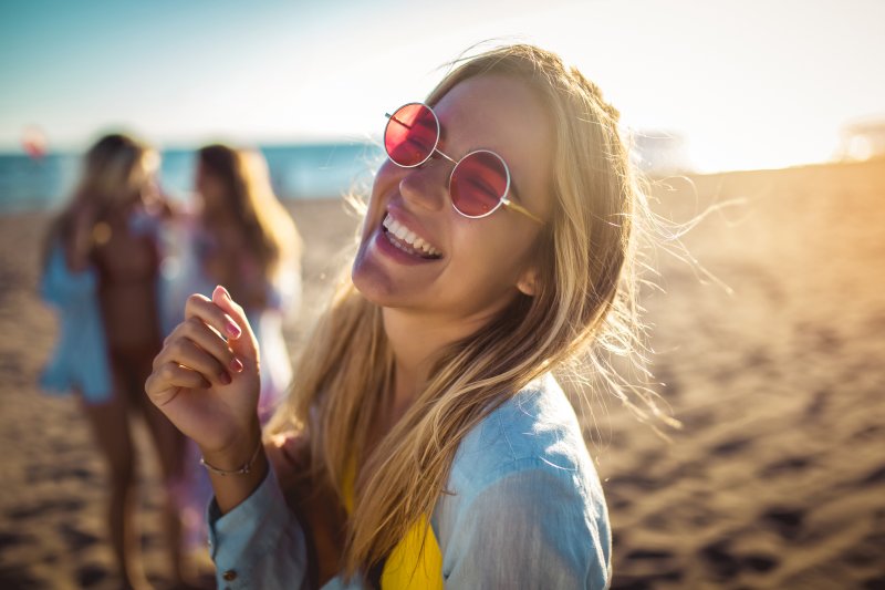 Happy young woman smiling on beach
