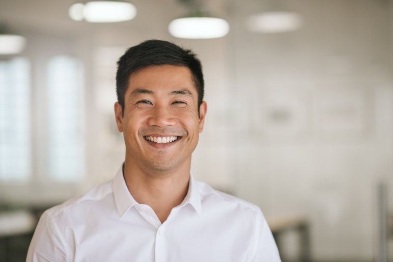 person smiling after having gray teeth fixed