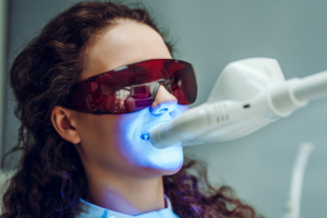 Woman having in-office whitening treatment