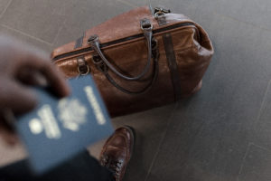 Passport and brown luggage