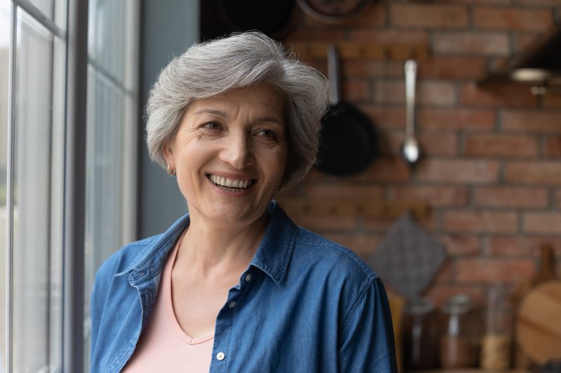 An older woman smiling with her new dentures