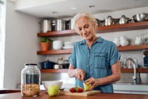 Woman with dentures cutting up her food