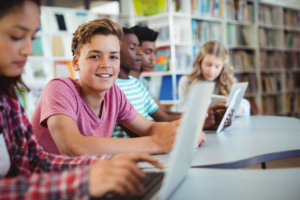 Kids studying on their laptops in the school library
