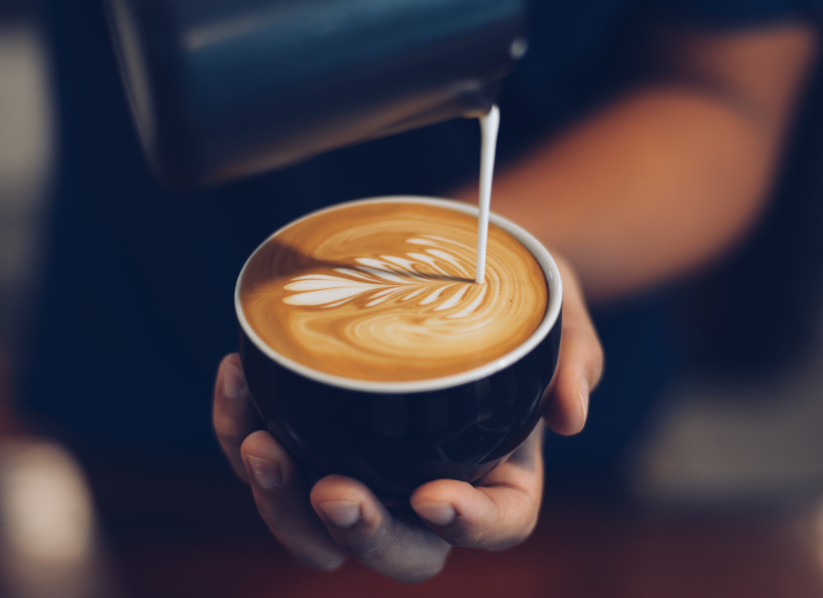 Barista pouring latte